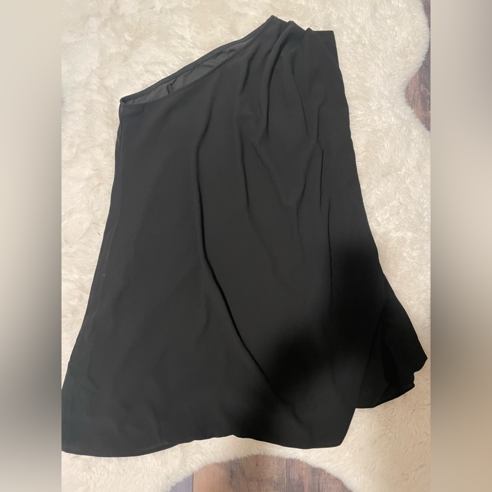 Small black one shoulder dress.